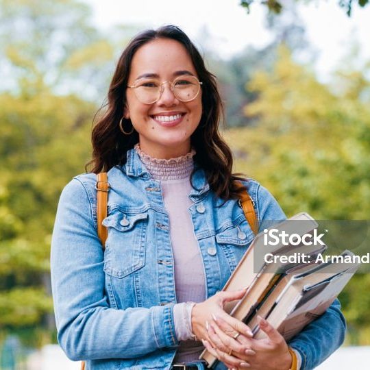 Woman, university student and books in portrait, outdoor and pride for learning, knowledge or happy in park. Girl, Japanese person and smile for scholarship, education and studying at college campus